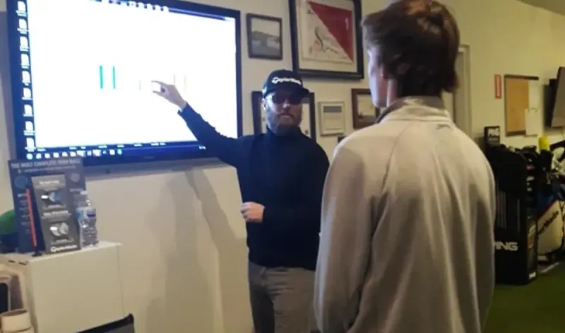 Jaime going over swing data on the big screen with a student